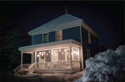 Renovated house at night in snow