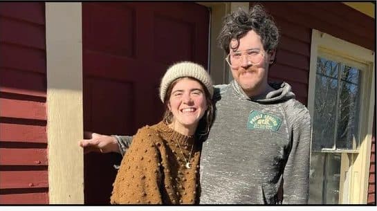 Couple on the porch of the Little Red House